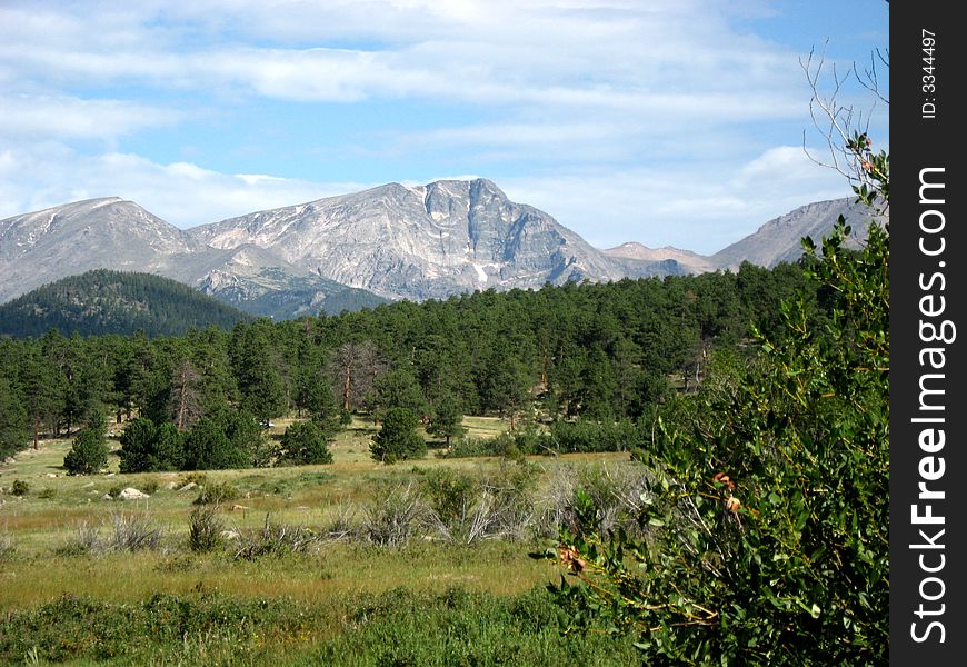 Rocky Mountains blue sky clouds and green trees. Rocky Mountains blue sky clouds and green trees.