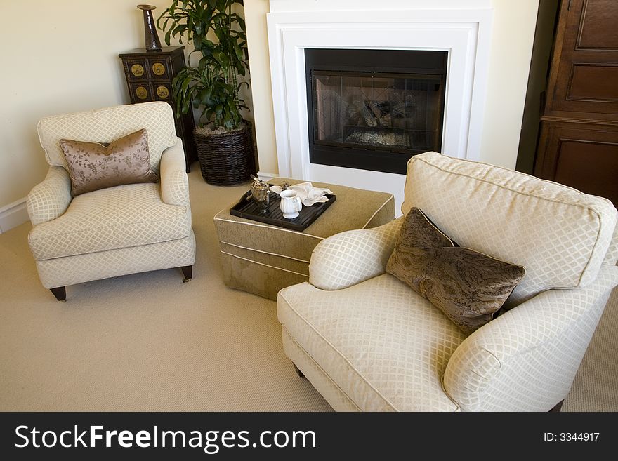 Comfortable bedroom with lounge area and modern fireplace. Comfortable bedroom with lounge area and modern fireplace.