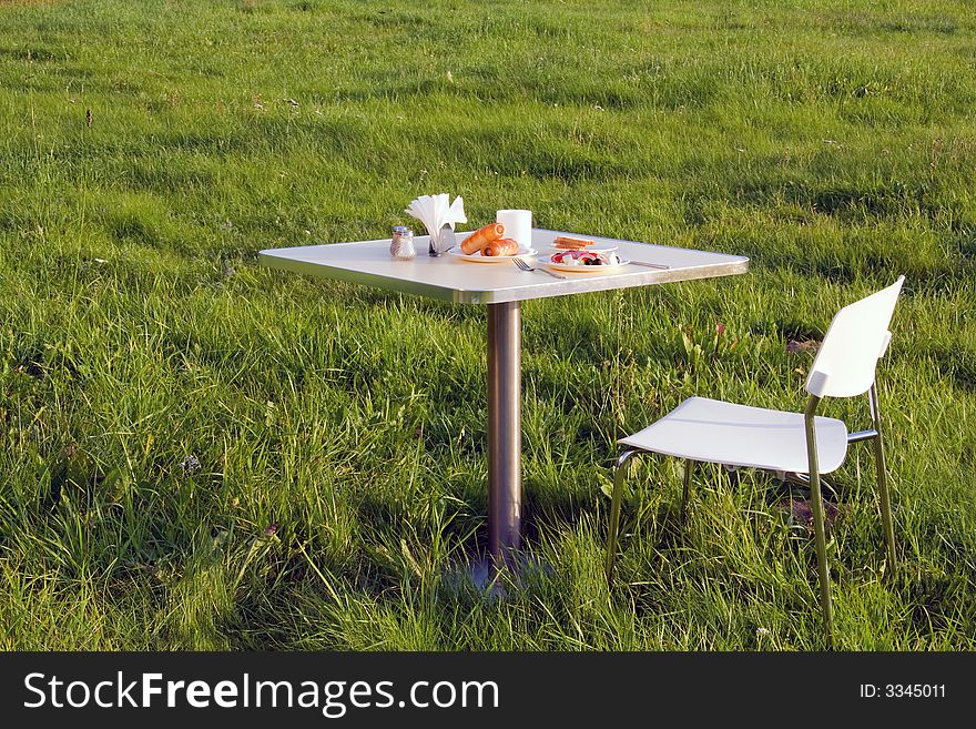 Table with breakfast at the grass