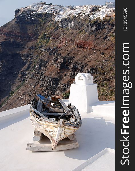An old boat on a rooftop in Santorini. An old boat on a rooftop in Santorini