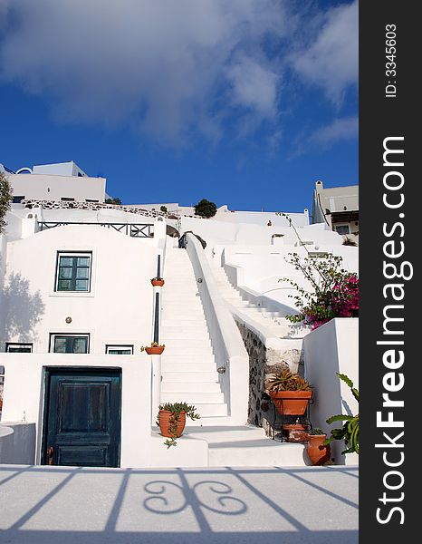 White stairway with terracotta pots in Santorini