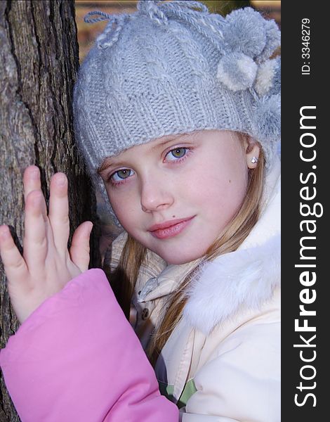 Little girl near tree looking at camera