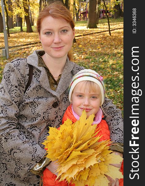 Mother and daughter with leafs