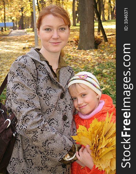 Mother and daughter with leafs