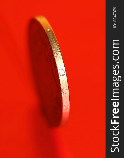 Close-up of coins on red background, macro (shallow DOF)