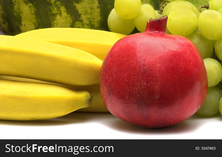 Fresh pomegranate on fruits background