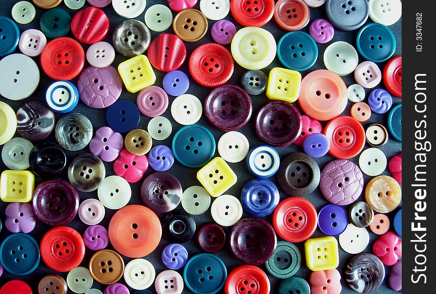 A lot of coloured collar studs on a black ground. A lot of coloured collar studs on a black ground