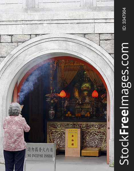Worshiper outside a buddha temple. Worshiper outside a buddha temple