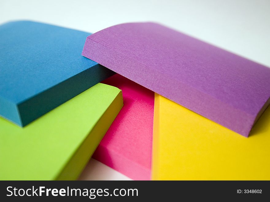 Stack of five different colored sticky note pads. Stack of five different colored sticky note pads.