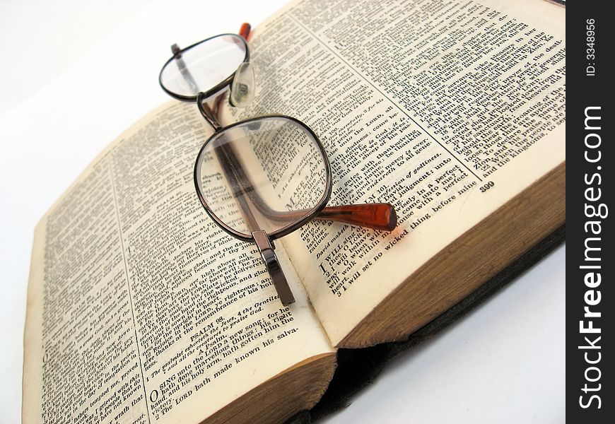 Open book with glasses on a plain background. Open book with glasses on a plain background