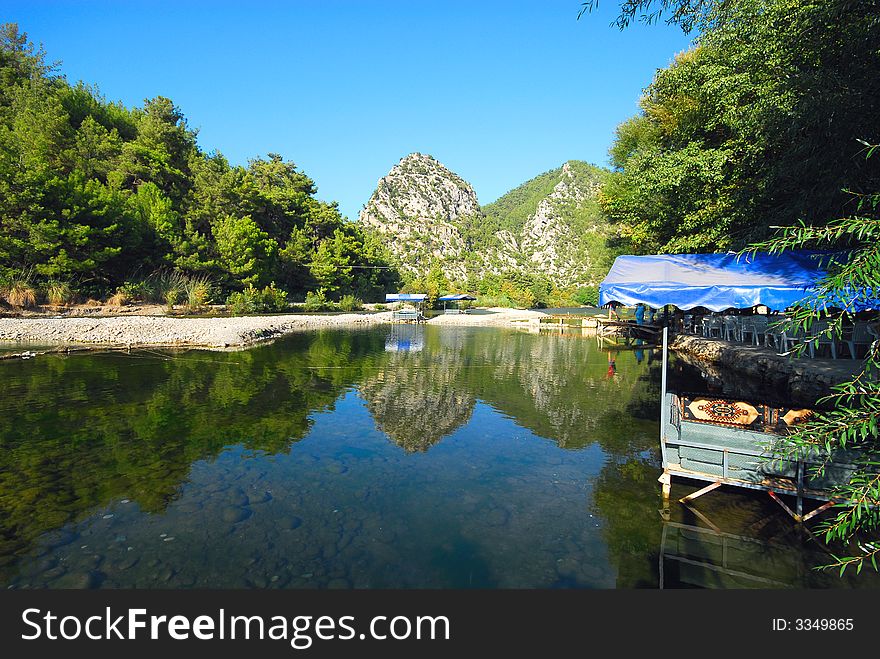 Summer cafe on coast of beautiful mountain lake