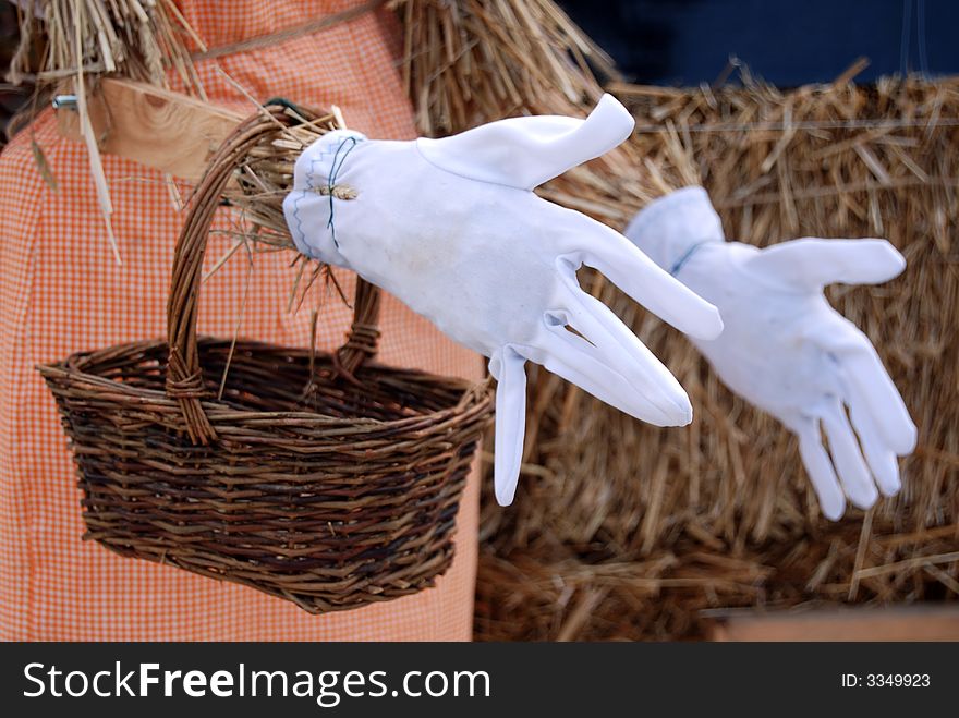 White dress gloves on a scarecrow hands. White dress gloves on a scarecrow hands.