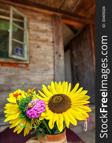 Flowers in front of old wooden house. Flowers in front of old wooden house.