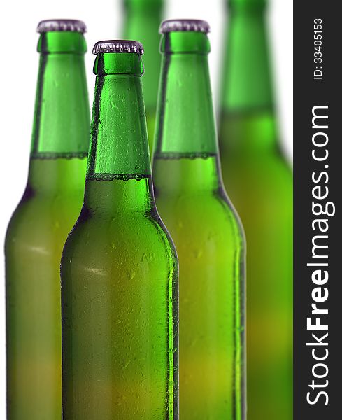 Row of beer bottles on a white