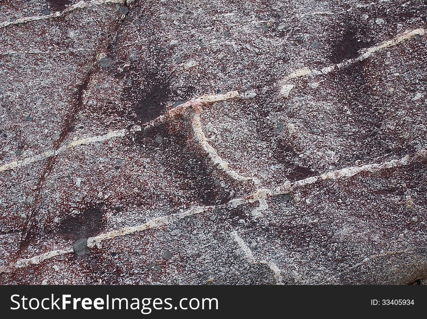 Surface of natural dark-red spotted stone with lines as background. Surface of natural dark-red spotted stone with lines as background