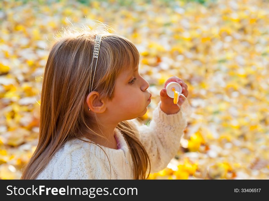 Little girl blowing soap bubbles