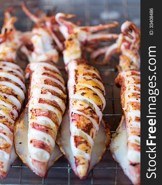 Fried squid on the grill. Shallow depth of field.