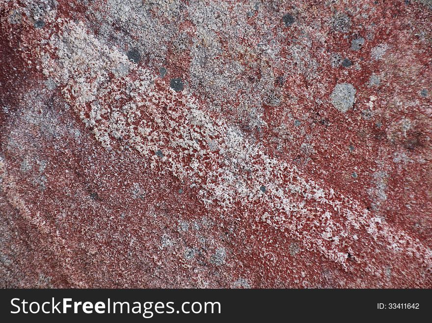 Surface of natural red and gray spotted stone with line as background. Surface of natural red and gray spotted stone with line as background