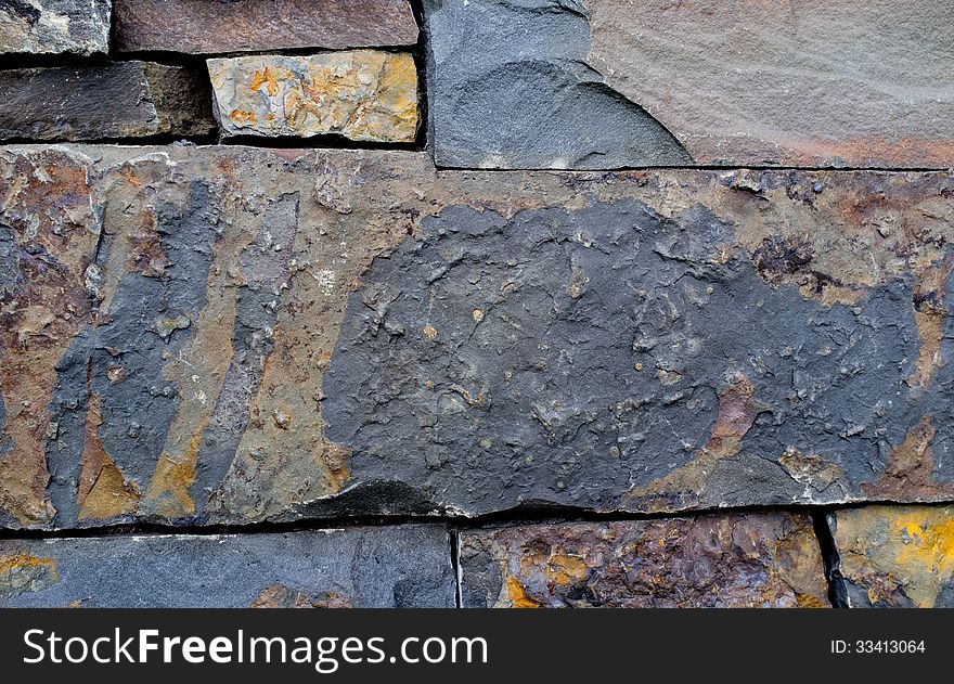 Wall made of slate tiles dry stacked together. Wall made of slate tiles dry stacked together