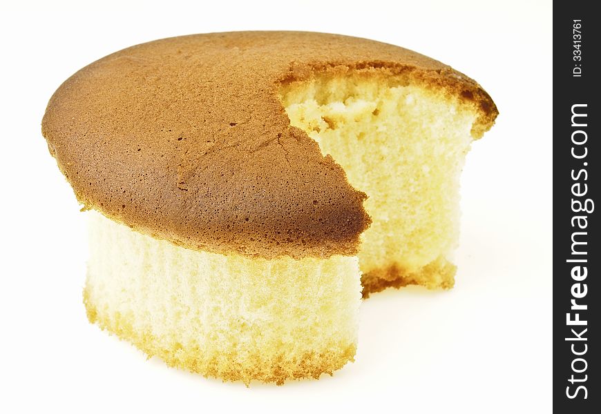 Sponge cake after small bite on white background. Sponge cake after small bite on white background