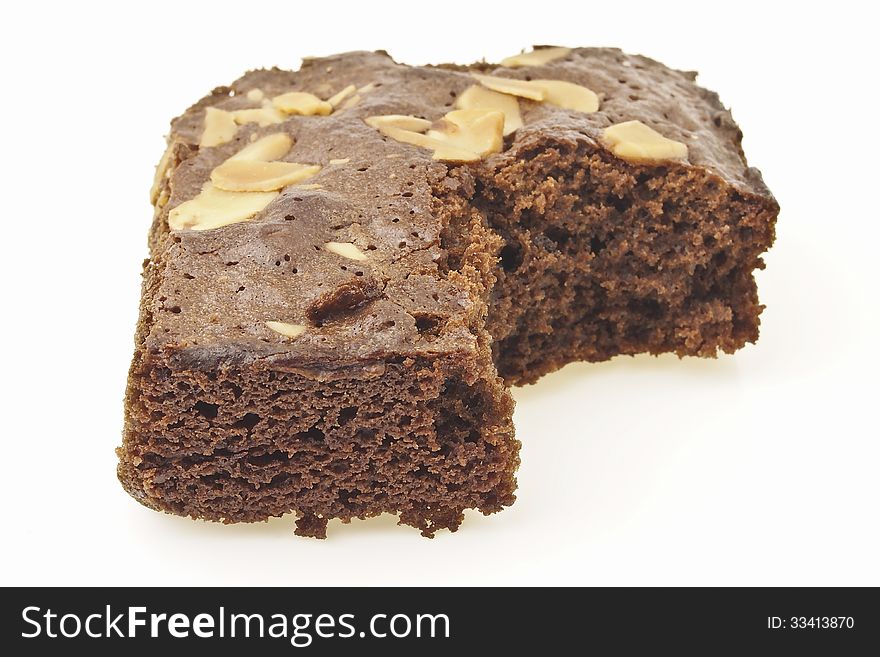 Piece of eating almonds brownies cake on white background. Piece of eating almonds brownies cake on white background