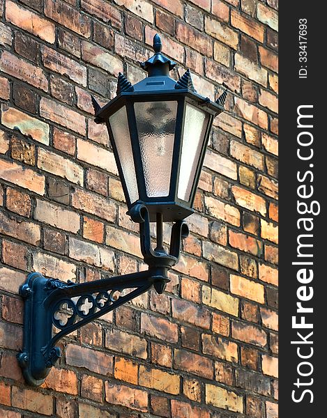 Vintage street lamp on a brick wall. Vintage street lamp on a brick wall