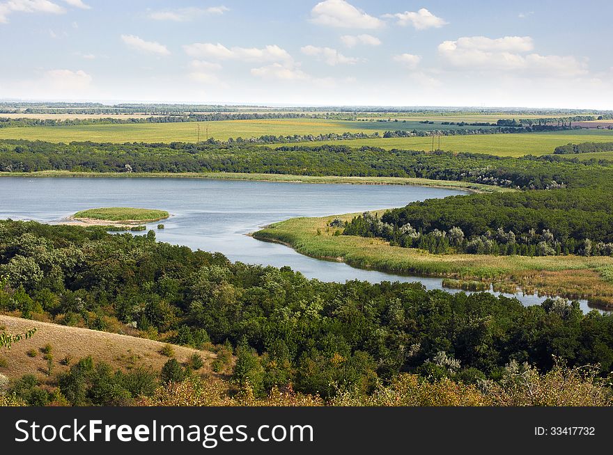 A winding, overgrown with reeds river Kleban Bull flows between the of hills. A winding, overgrown with reeds river Kleban Bull flows between the of hills