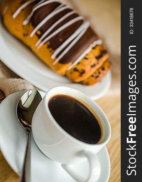 Chocolate bun with cup of coffee. Chocolate bun with cup of coffee