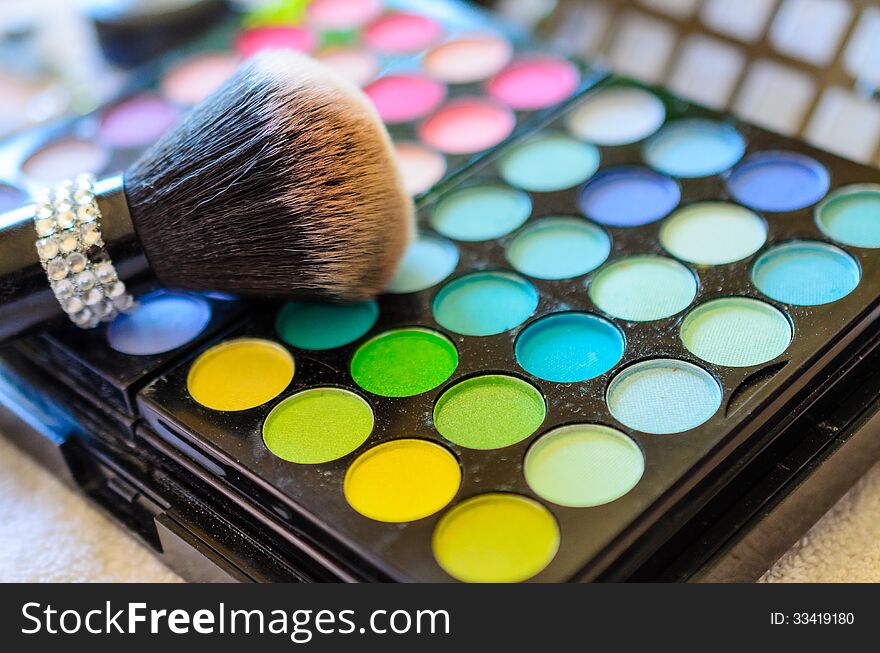 Closeup of makeup kit and brush