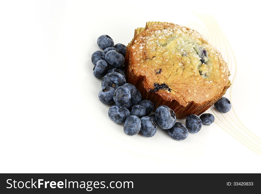 Delicious big blueberry muffin with fresh blueberries in front
