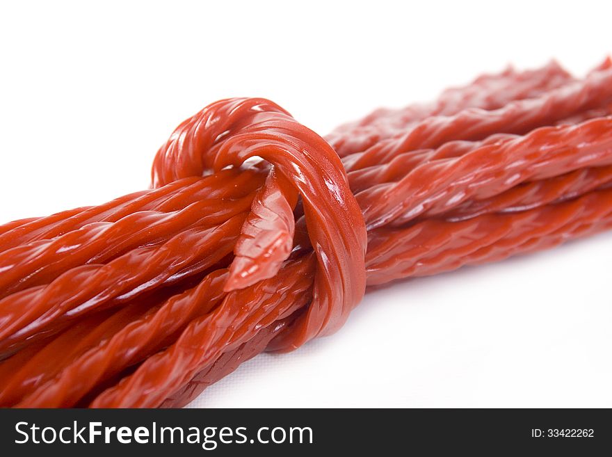 red liquorice candy over white background