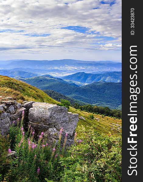 Panorama of mountains and rocky ledge on the hillside. vertical