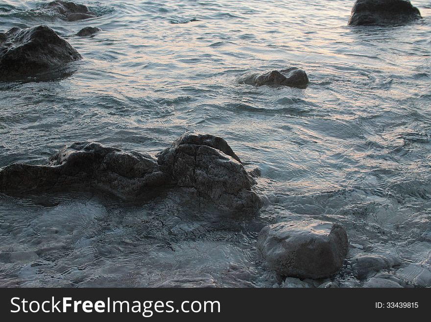 Rocks on the shoreline, blue sea. Rocks on the shoreline, blue sea