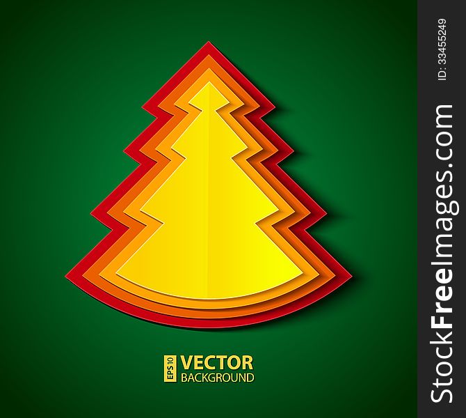 Red, orange and yellow paper folded christmas tree on green background. Red, orange and yellow paper folded christmas tree on green background