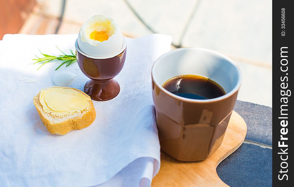 Outdoor breakfast with boiled egg and cup of coffee