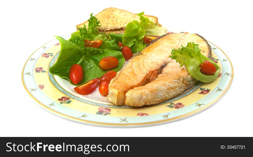 Grilled salmon with vegetables isolated on white