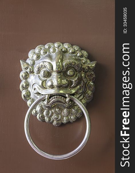 Traditional chinese door handle and knocker in symbolic lion head as an guardian