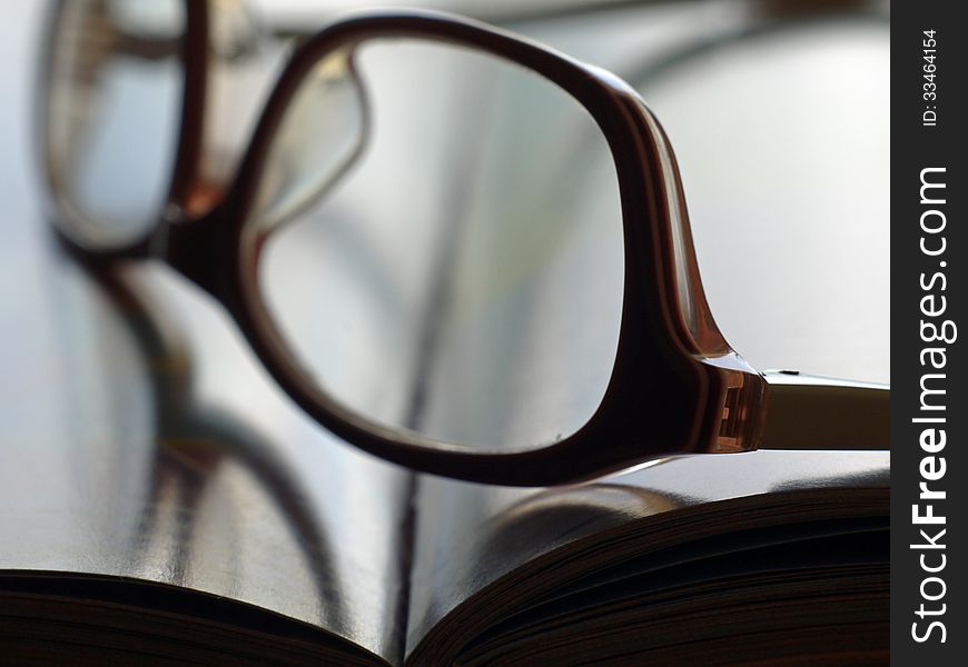 Open book with pages and eyeglasses in close. Open book with pages and eyeglasses in close