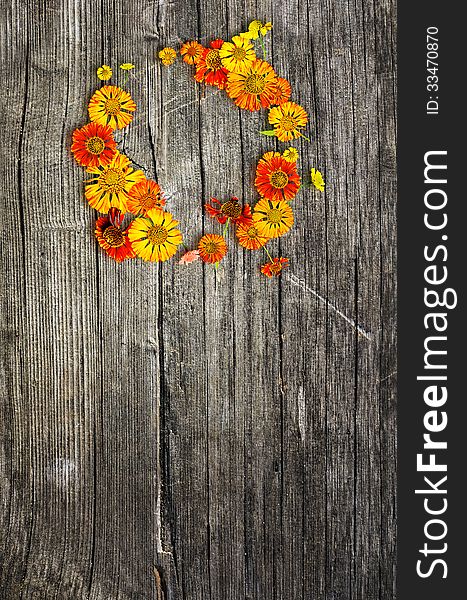 Flower wreath on wooden background