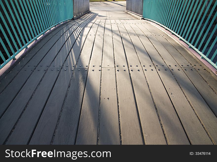 Wooden floor bridge with green railings