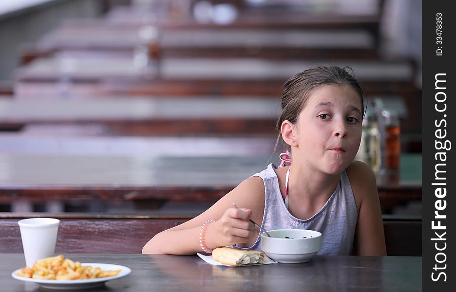 Girl having lunch at an outdoor restaurant. Girl having lunch at an outdoor restaurant