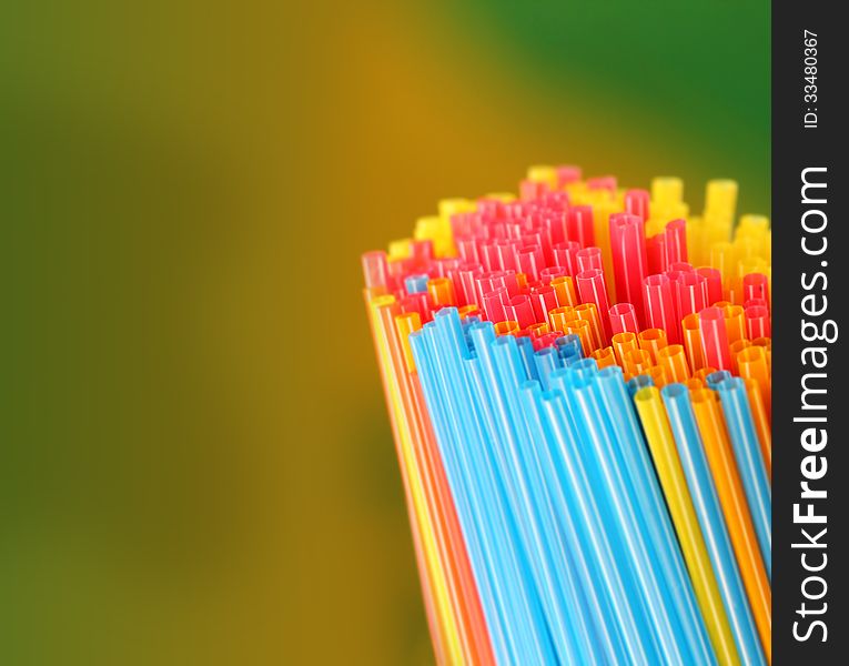 Green, yellow, blue, pink & red colored straws group