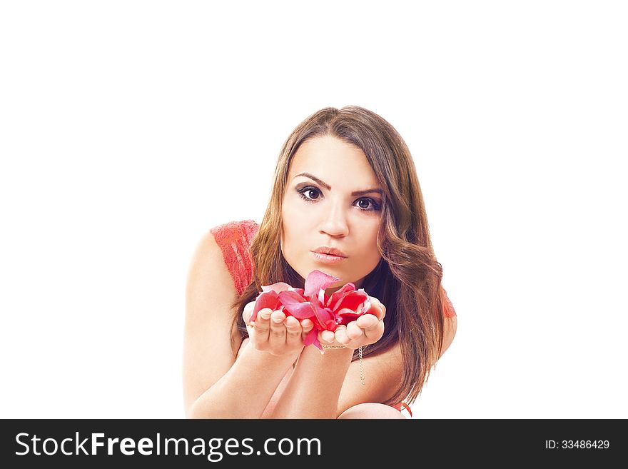 girl blowing petals of roses