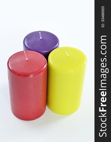 Colored candles on white background