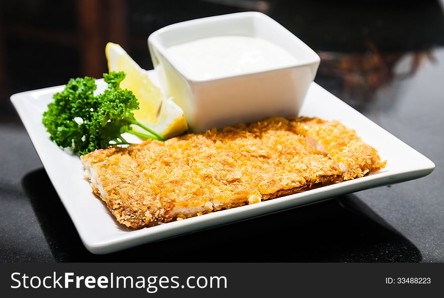 Fried bread crumbs pork and lemon mayonnaise with parsley