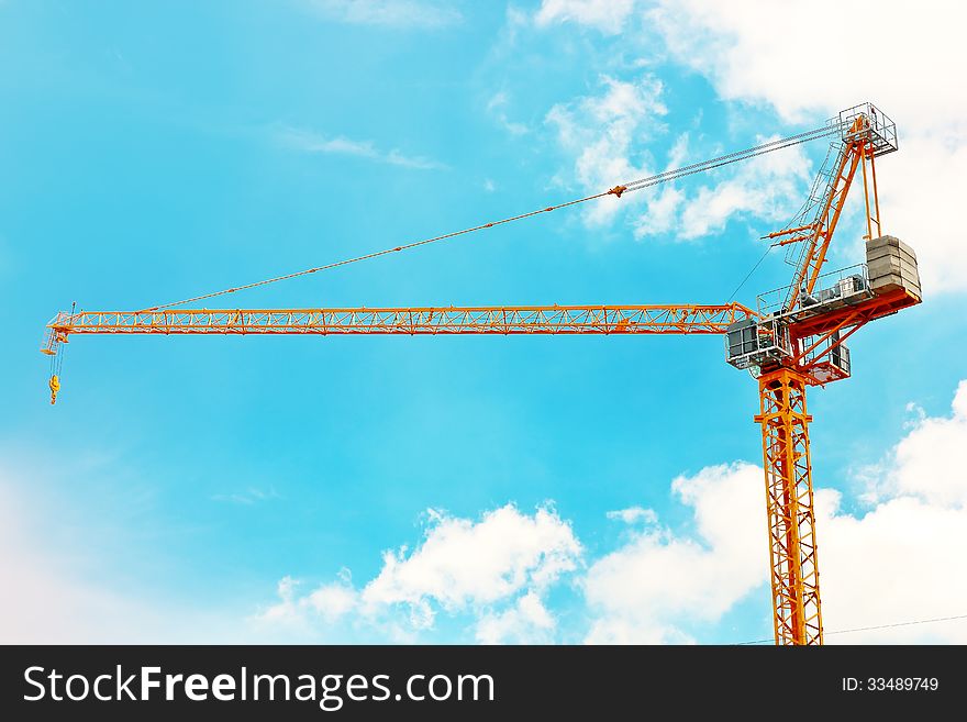 Derrick at construction zone over blue sky