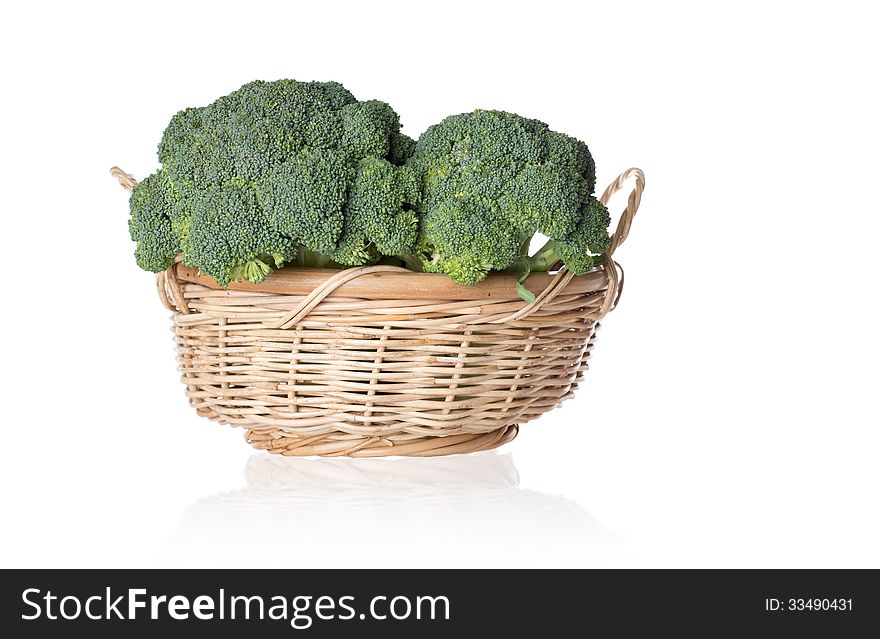 Two broccolies in a basket isolated on white background. Two broccolies in a basket isolated on white background.