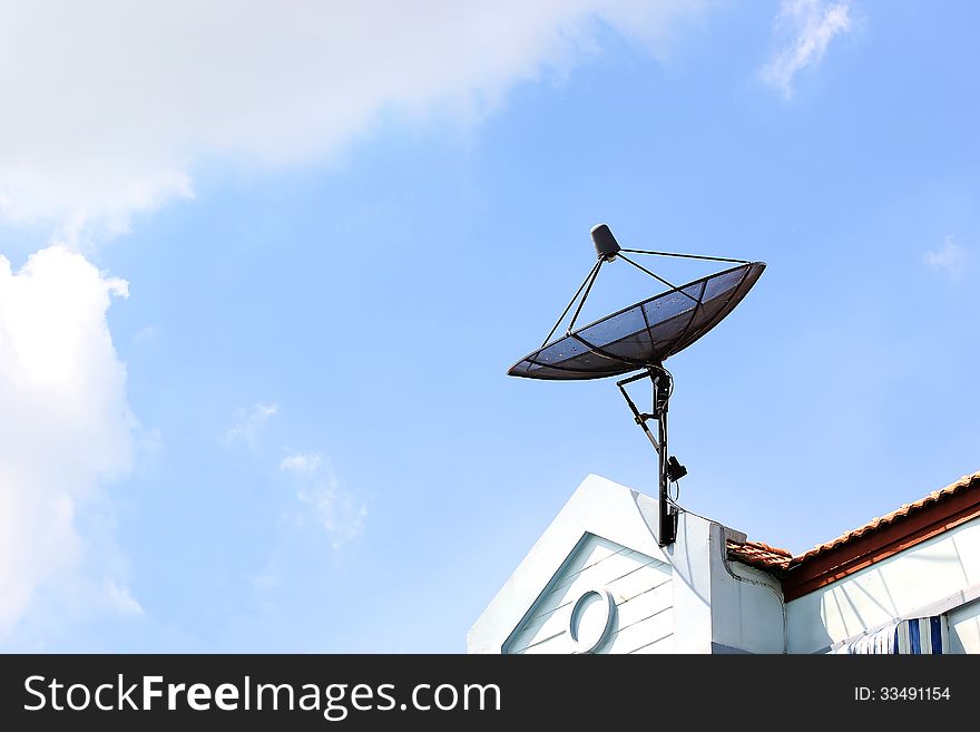 Satellite dish on roof with beautiful sky