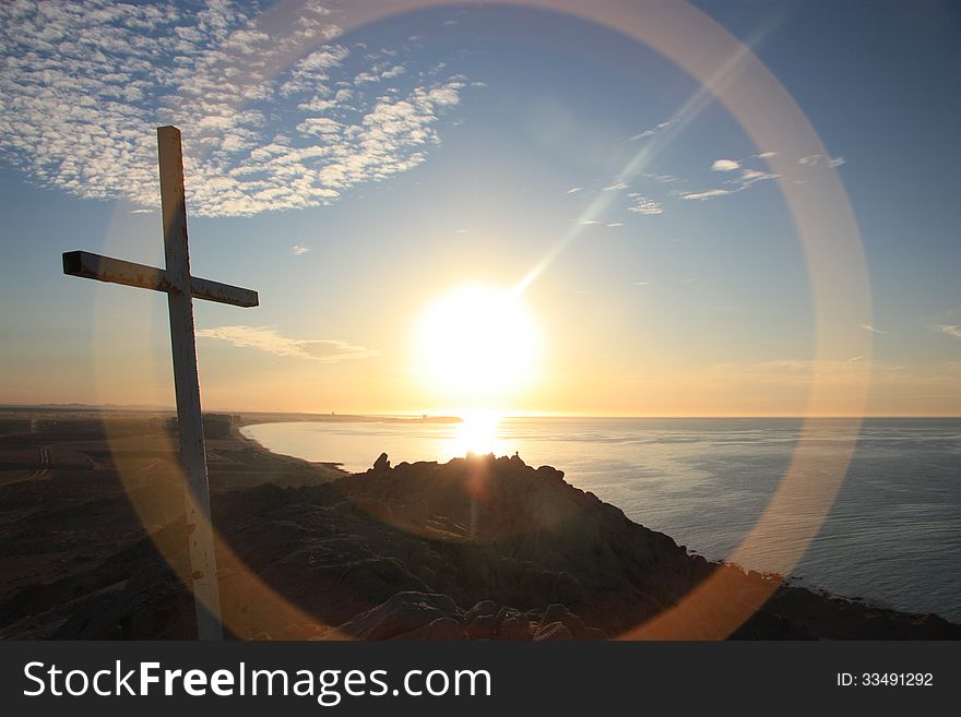 Coastal cross silhouette in the sunset. Coastal cross silhouette in the sunset