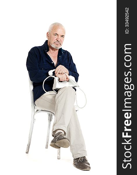 Man Sitting On A Chair And Holding Electric Iron